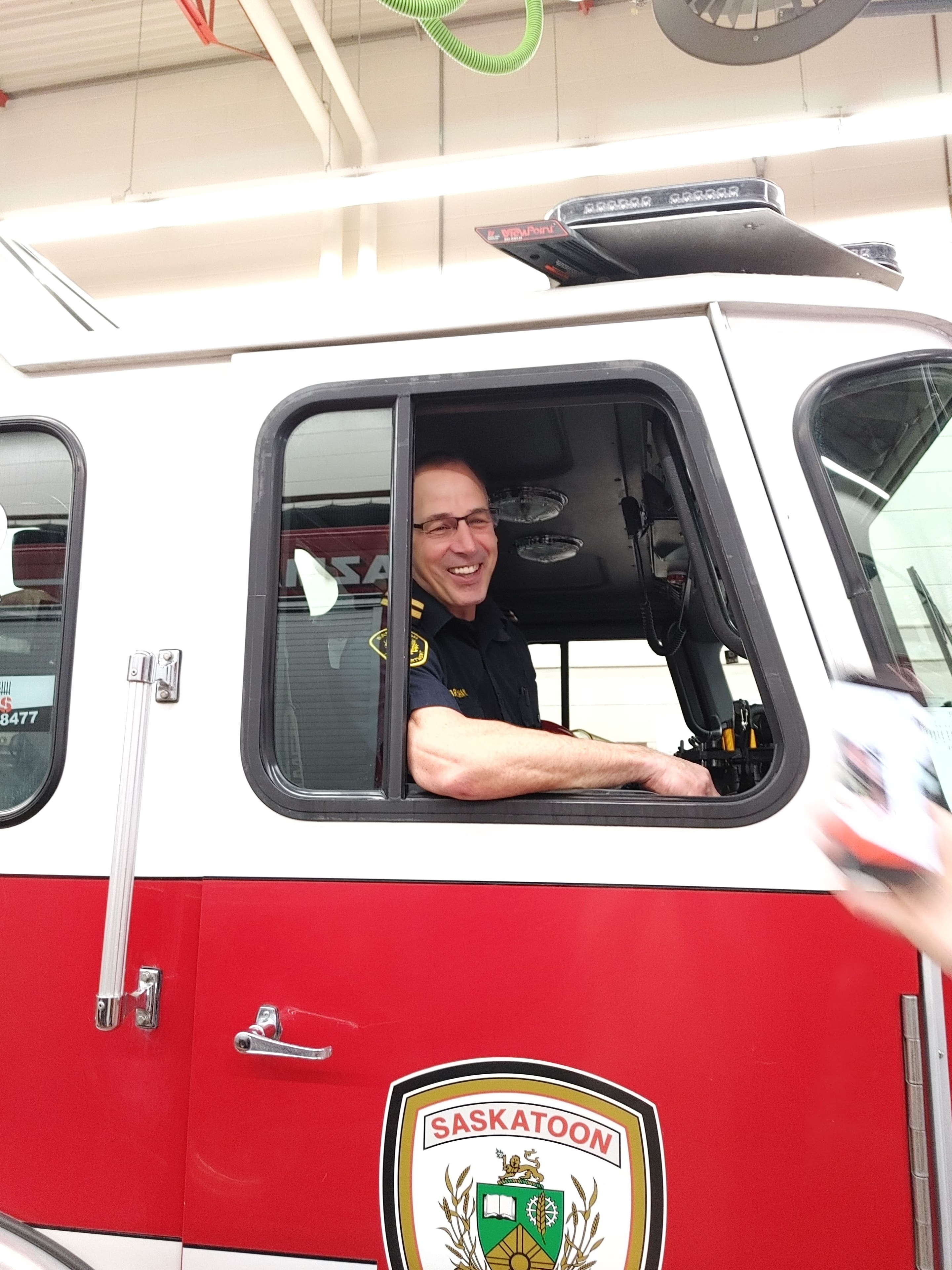 Jim Brayshaw as Fire Captain in the cab of a Saskatoon fire truck